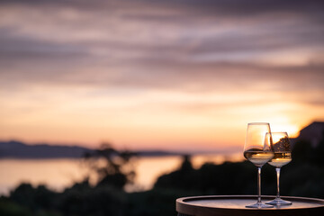 Two glasses of white wine with the sea in the background