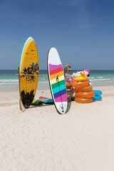 Colorful sup board are lying on the beach, waiting for tourists to play.