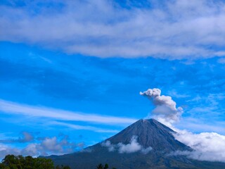 Obraz premium Scenic View of Mount Semeru with Rising Smoke in morning. 