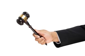 Hand holding Judge's gavel hammer on white background.