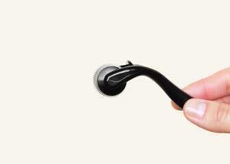 Microneedling Roller Held by Hand