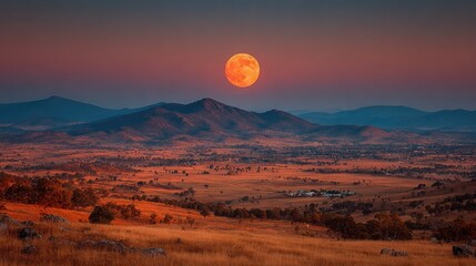 Fototapeta premium Moon illusion effect with enormous lunar disk appearing above distant horizon line, atmospheric perspective enhancing size