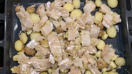 Golden-brown roasted potatoes and succulent chicken pieces exude rustic autumnal comfort,...