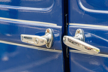 Close-up of vintage car double doors with chrome handles