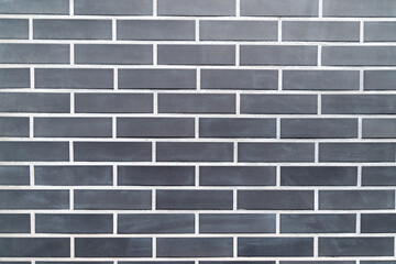 Black brick wall with uniform rectangular pattern