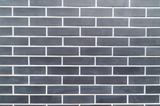 Black brick wall with uniform rectangular pattern - Powered by Adobe