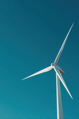 Captivating view of a wind turbine soaring against the backdrop of a vibrant blue sky near a sustainable energy site
