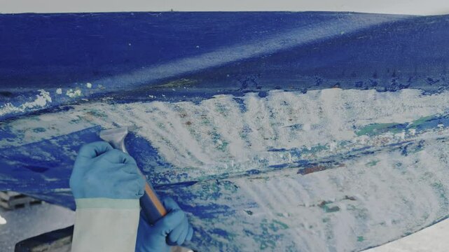 Antifouling scrap tool removing old paint boat hull to leave gelcoat clean