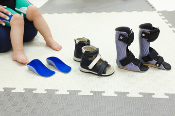 Selection of right orthopedic shoes or orthoses for child with valgus deformity of feet in rehabilitation center. Orthopedic shoes for treatment of foot deformities