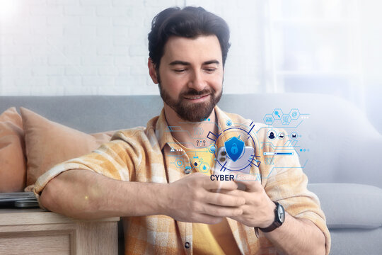 Handsome man using mobile phone at home - Powered by Adobe