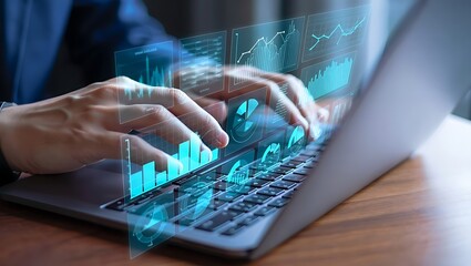 Photo of hands interact with a laptop displaying vibrant blue data charts and graphs
