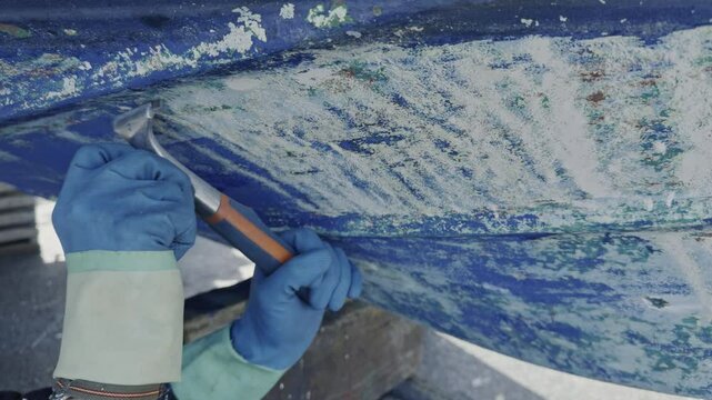 Antifouling scrap tool removing old paint boat hull to leave gelcoat clean