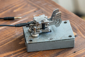 An old amateur Morse key on a table in close-up