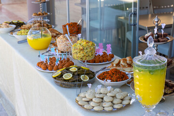 Outdoor catering buffet with a variety of food snacks and appetizers