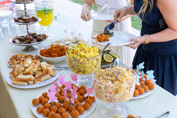 Outdoor catering buffet with a variety of food snacks and appetizers