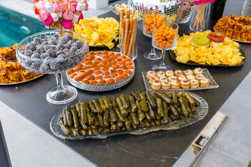 Outdoor catering buffet with a variety of food snacks and appetizers