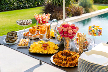 Outdoor catering buffet with a variety of food snacks and appetizers