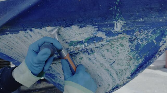 Antifouling scrap tool removing old paint boat hull to leave gelcoat clean