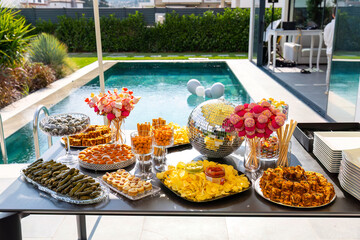 Outdoor catering buffet with a variety of food snacks and appetizers