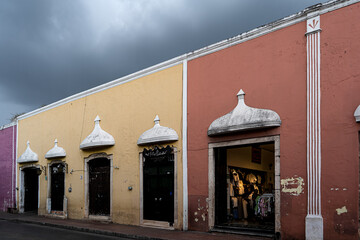 Traditional colorful buildings showing colonial architecture in valladolid, yucatan, mexico, under a cloudy sky