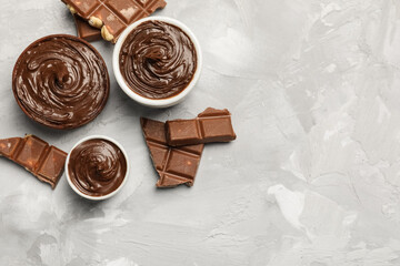 Bowls of tasty chocolate spread on grunge background