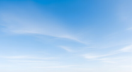 Clear blue sky with wispy clouds creating a tranquil natural atmosphere