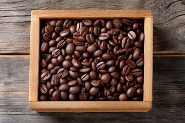 Fototapeta premium Roasted coffee beans fill a square wooden box on a weathered wood surface