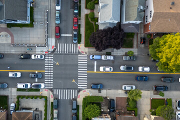Cars at a street intersection separated by a yellow line.