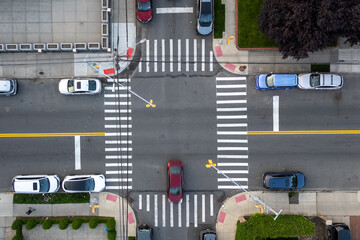 Cars at street intersection with yellow line.