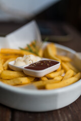 French fries served with ketchup and mayonnaise. Selective focus