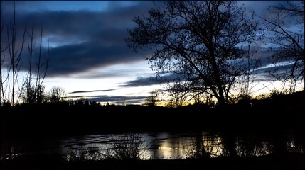 Dark landscape silhouettes at dusk horizon