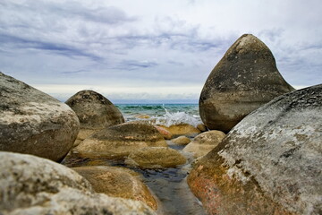 Northern Kyrgyzstan. The landscape of the cold lake Issyk-Kul with colorful round stones of...