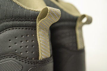 Mountain climber mid-cut hiking boots Pull Loop attached on backstay with holes for air circulation.