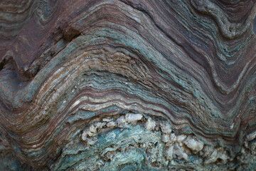 A detailed close-up of layered sedimentary rock displaying intricate. Perfect for backgrounds, textures, and educational geology content.