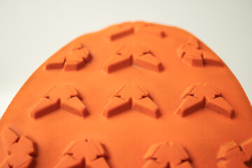 Close-up of hiking boot outsole with deep tread patterns, designed for superior grip, durability,...