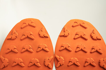Close-up of hiking boot outsole with deep tread patterns, designed for superior grip, durability,...
