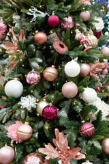 Festive decorations adorn a beautifully arranged Christmas tree featuring pastel ornaments and twinkling lights inviting joyful holiday spirit