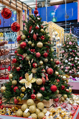 Festive decorations adorn a beautifully arranged Christmas tree featuring pastel ornaments and twinkling lights inviting joyful holiday spirit