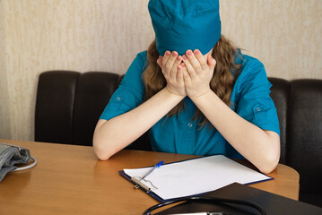 Healthcare worker in distress sitting alone on the floor in a quiet room