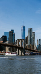 Fototapeta premium NYC from brooklyn bridge, views at the skyline of nyc, flag of usa