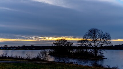 Fototapeta premium Gloomy landscape at dusk with lake