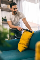 Man Cleaning Couch