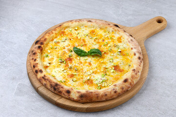 Wood-Fired White Pizza with Melted Cheese, Pistachios, and Fresh Basil