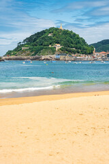 Santa Clara Island in front of the city of San Sebastian visited by crowds of tourists, photo with copyspace.