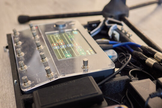 A Unique Collection of Guitar Effects Pedals Carefully Arranged on an Effect Board