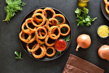 Onion rings with tomato sauce on plate