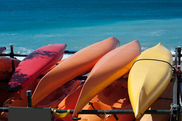 Kayaks on the turquoise sea on the promenade of Camogli, Liguria, Italy