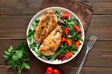 Roasted chicken breast and vegetable salad on plate