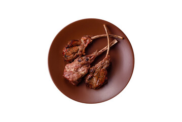 Juicy meat on the bone or rack of lamb. Grilled veal with salt, spices and herbs