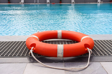 lifebuoy near swimming pool. swimming pool safety ring near swimming pool. Safety concept.